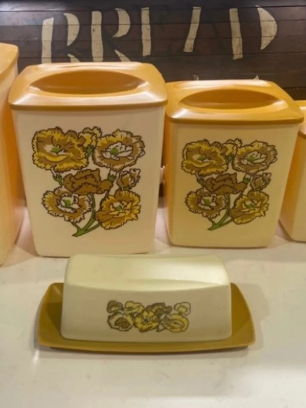 vintage 1970s plastic Retro Daisy canister set with a matching butter dish